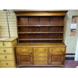 A GEORGE III WELSH OAK DRESSER, the wide boarded rack over a 'T' arrangement of six opening