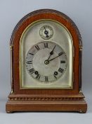 A DOME TOPPED MAHOGANY EDWARDIAN MANTEL CLOCK, the silvered dial set with Roman numerals and slow-