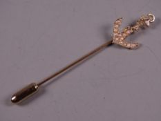 AN UNMARKED GOLD STICK PIN with seed pearl encrusted anchor, 2.2 grms