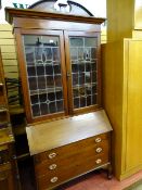 A CIRCA 1900 INLAID MAHOGANY BUREAU BOOKCASE with leaded glazed doors (damaged), 213 cms high, 99