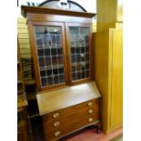 A CIRCA 1900 INLAID MAHOGANY BUREAU BOOKCASE with leaded glazed doors (damaged), 213 cms high, 99