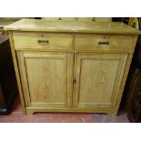 A VINTAGE LIGHT OAK TWO DRAWER, TWO DOOR CABINET, 107 cms high, 122 cms wide, 56.5 cms deep