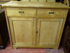 A VINTAGE LIGHT OAK TWO DRAWER, TWO DOOR CABINET, 107 cms high, 122 cms wide, 56.5 cms deep