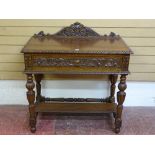 A CARVED OAK SINGLE DRAWER HALL TABLE with rail back and egg and dart moulding, on reeded block