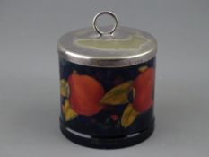 A MOORCROFT 'POMEGRANATE' JAM POT, 7.75 cms diameter, with electroplate lid, decorated on a cobalt