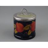 A MOORCROFT 'POMEGRANATE' JAM POT, 7.75 cms diameter, with electroplate lid, decorated on a cobalt