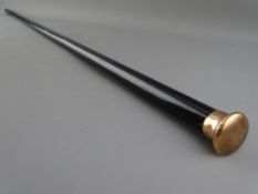 A NINE CARAT GOLD TOPPED EBONY WALKING CANE, monogrammed to the top with various side markings