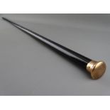 A NINE CARAT GOLD TOPPED EBONY WALKING CANE, monogrammed to the top with various side markings