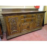A GOOD CIRCA 1900 OAK SIDEBOARD with carved oak detail to the door panels, interior cellar and