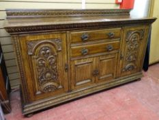 A GOOD CIRCA 1900 OAK SIDEBOARD with carved oak detail to the door panels, interior cellar and