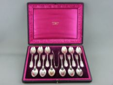 A GOOD CASED SET OF TWELVE LARGE SILVER TEASPOONS with tongs, fiddle thread and shell pattern by