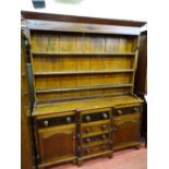 A 19th CENTURY ANGLESEY TALWRN OAK PINE & MAHOGANY DRESSER, the base cupboard doors with raised