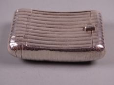 AN OBLONG SLIGHTLY CURVED SILVER SNUFF BOX with end hinged lid and all over lined decoration, 1.7