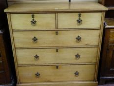 A LATE VICTORIAN BLONDE OAK CHEST of two short over three long drawers with slight Gothic