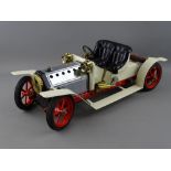 A MAMOD STEAM ROADSTER MOTOR CAR in cream and red livery