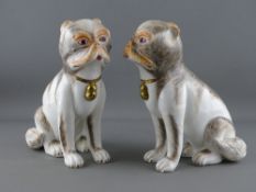 A PAIR OF SUTHERLAND BONE CHINA PUG DOGS, seated and having painted detail and gilt decorated collar