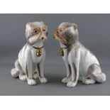A PAIR OF SUTHERLAND BONE CHINA PUG DOGS, seated and having painted detail and gilt decorated collar