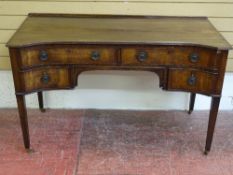 A REPRODUCTION REGENCY STYLE MAHOGANY DESK, the shaped front having an arrangement of four drawers