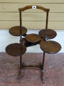 A VINTAGE MAHOGANY METAMORPHIC CAKESTAND, patent label attached 'THE MONOPLANE', 77 cms high