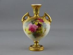 A ROYAL WORCESTER TWIN HANDLED VASE, 2249 shape, gilt decorated with floral body, 16 cms high