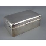 A RECTANGULAR SILVER CIGARETTE BOX, the lid with engine turned decoration, 13.5 cms long,