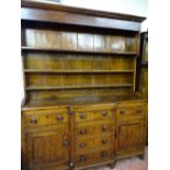 A MID 19th CENTURY ANGLESEY OAK BREAKFRONT DRESSER, wide boarded rack over a well coloured panel