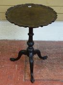 A VICTORIAN MAHOGANY TILT TOP TRIPOD TABLE with piecrust edge, 71 cms high, 51 cms diameter the top