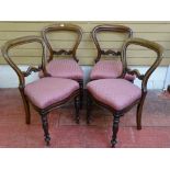 A SET OF FOUR VICTORIAN MAHOGANY BALLOON BACK CHAIRS with carved detail to the crossrails and