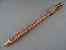 A CHINESE CARVED SOAPSTONE OPIUM OR TOKE PIPE with stained colour highlighting and seal script