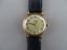 A NINE CARAT GOLD CASED GENT'S WRISTWATCH with leather strap, the dial marked Elco, 15 Jewels, set