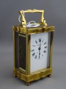 Vintage brass cased carriage clock, the dial marked 'W Greenwood & Sons, Leeds & Huddersfield' (