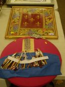 Lace worker's pad with beaded bobbins and a framed needlework panel