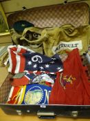 Vintage hard shell suitcase with an assortment of flags, militaria caps, canvas haversacks and