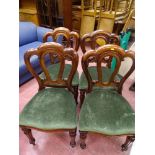 Set of four balloon back dining chairs with tapered front legs and green upholstery