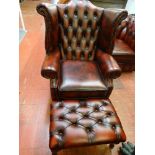 Wing back red leather armchair and a footstool