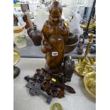 Treen items to include a carved monk figurine, a quantity of modern lovespoons etc