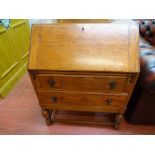 Oak two drawer writing bureau with interior sliding compartment