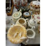 Collection of vintage teapots and a carved stone pedestal bowl with birds