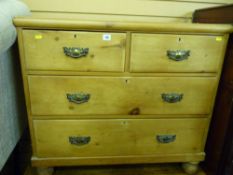 Antique stripped pine chest of two short over two long drawers on bun feet