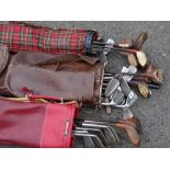 Three bags of modern and vintage golf clubs