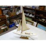 Model yacht on stand with sails, 77 cms long