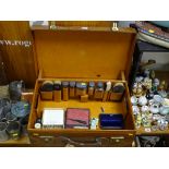 Vintage travelling suitcase by Finnigans with silver topped bottles and brushes within and a
