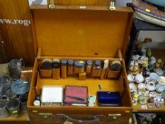 Vintage travelling suitcase by Finnigans with silver topped bottles and brushes within and a