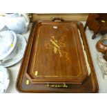 Three vintage trays including a brass handled example with musical instruments inlay