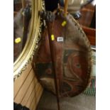 Painted African hide shield and a lion's head carved walking cane