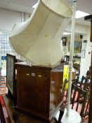 Vintage mahogany bedside cabinet on ball and claw supports and a white painted standard lamp with