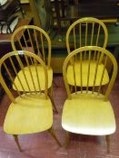 Four light wood Ercol style stickback dining chairs