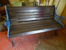 Wooden slatted garden bench with cast metal ends