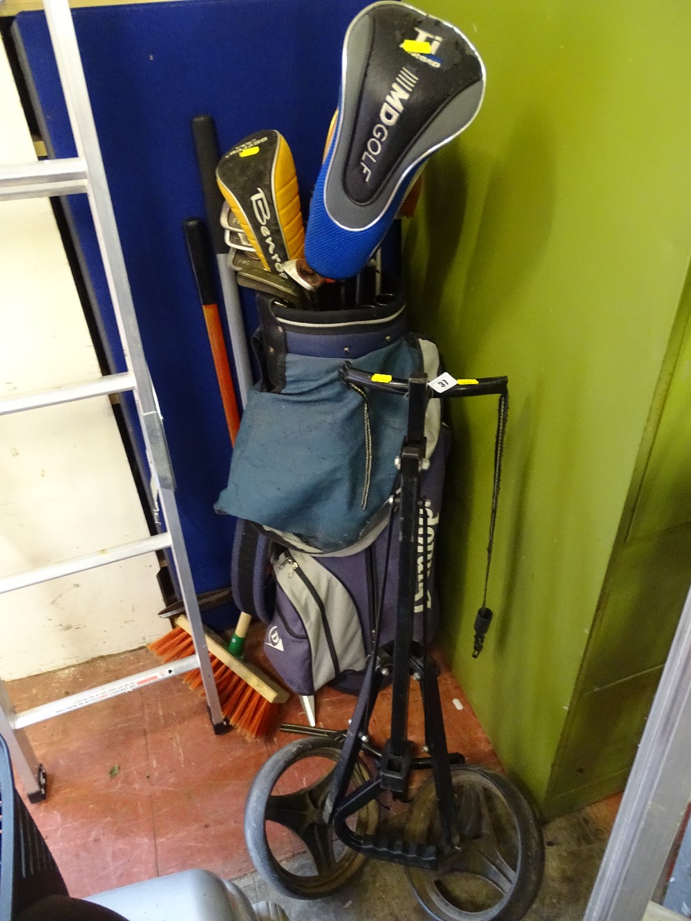 Golf trolley with Dunlop bag containing quantity of golf clubs and a small selection of long handled