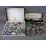 Four silver napkin rings and a pair of boxed golfing spoons along with a boxed collection of semi-